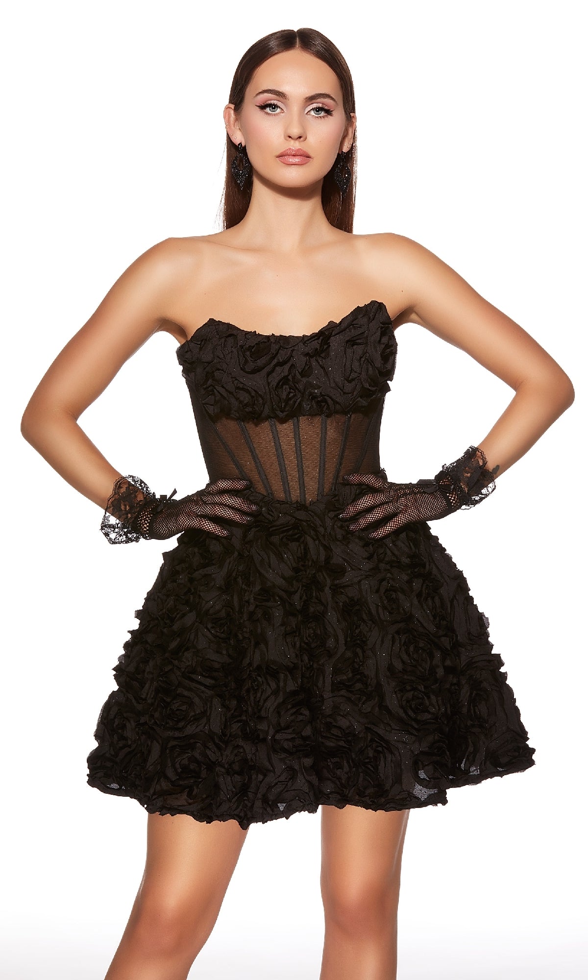 Woman in Alyce 30079 short homecoming dress featuring a strapless corset-style bodice, sheer paneling, and textured floral details, paired with black lace gloves, standing against a white backdrop.